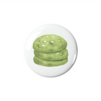 Green matcha cookies in a glass dome on a white background