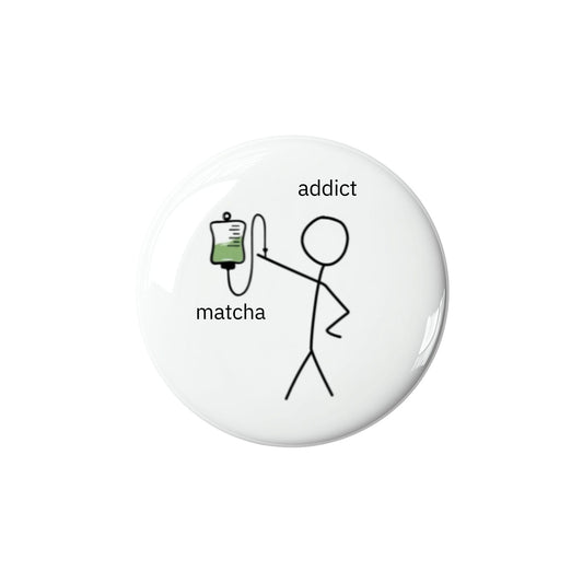Button badge with a stick figure holding an IV labeled 'addict' and 'matcha' on a white background